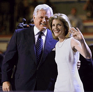 Massachusetts Senator Edward Kennedy puts his arm around his niece, Caroline Kennedy Schlossberg, as she waves to delegates on the second day of the Democratic National Convention in Los Angeles on Tuesday