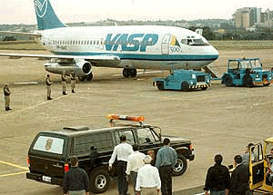 Police stand guard around a VASP airlines jet in Londrina, Brazil on Wednesday. Earlier in the day, armed men hijacked the plane with 72 people aboard and forced the pilot to land at an isolated airstrip in southern Brazil. They then fled with at least $3.3 million in stolen cash. Most of the 66 passengers were tourists from Italy, France and Japan returning from the famous Iguacu Falls on the border with Argentina. No one was hurt