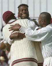 West Indies fast bowler Curtly Ambrose, facing camera, celebrates with team mates his 400th cricket test wicket , after dismissing England's Michael Atherton, during the first day of the 4th test between England and the West Indies at Headingley, Leeds, Engalnd on Thursday