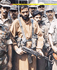 Top Hizbul Mujahideen commanders Mohammed Arif, left, with beard, and Mohammed Shabi, right, with beard, surrender to the Army in Jammu on Friday. This is the first surrender by Hizbul Mujahideen commanders since the group called off a ceasefire with Indian forces last week