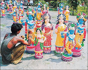 Rawat Ram gives finishing touches to these idols of Lord Krishna and Radha near GT Road, Ludhiana. � Photo by Rajesh Bhambi