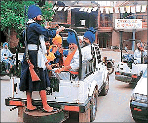 Armed supporters taking round outside a polling station during the civic poll in Phase-VII SAS Nagar on Sunday � Tribune photo by Parvesh Chauhan