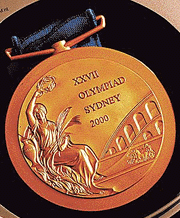 The gold medal that will be awarded at the Sydney 2000 Olympic Games.The Games organisers are having to explain a mistake that has upset the local Greek community in the design of the Sydney 2000 gold, silver and bronze medals which picture the colosseum in Rome rather than the Parthenon in Athens