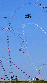 Kite trains, kite arches and multiline stacks of kites fill the air over the boardwalk in Long Beach, Wash., Monday, Aug. 21, 2000 as during the 18th annual Washington International Kite Festival