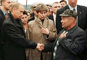 Russian President Vladimir Putin shakes hands with an unidentified relative of a seaman, who is believed dead aboard the crippled nuclear submarine Kursk, in the closed military base of Vedyayevo, 80 km north from Murmansk on Tuesday