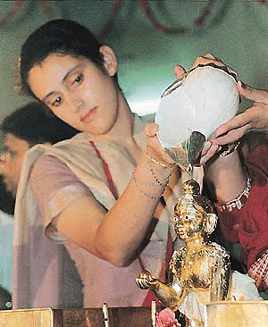 One of the devotees offers milk to Lord Krishna on the occasion of Janamashtami at ISKCON, Sector 36, in Chandigarh on Wednesday night.         � Tribune photo by Pankaj Sharma