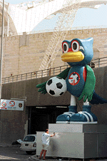 A worker puts the finishing touches on the mascot for the Asian Cup 2000 tournament outside the Sports City stadium in Beirut on Thursday