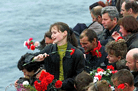 Relatives of sailors who died aboard the sunken nuclear submarine Kursk drop flowers from a ship in the Barents Sea to commemorate the 118 Kursk on Thursday