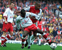 Arsenal's Thierry Henry,behind, tries to take the ball from Charlton Athletic's Richard Rufus during the English Premier League soccer match at Arsenal's Highbury stadium north London on Saturday