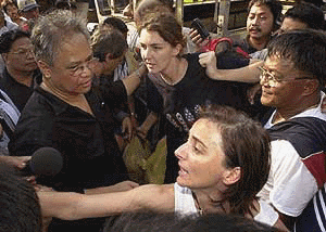 JOLO : Freed French hostages Maryse Burgot, foreground, and Sonya Wendling, background, are received by Philippine chief negotiator Robert Aventajado, left, while emissary Ernesto Pacuno, right, looks on in Jolo after after being released by the Muslim extremists group Abu Sayyaf  on Sunday.  Five foreign hostages were released Sunday, following156 days in captivity