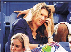 Steffi Graf watches her boyfriend Andre Agassi of the USA lose his match to Arnaud Clement at the US Open in New York on Thursday. 