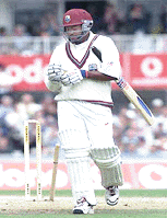 West Indies batsman Brian Lara walks off after being bowled by England's Craig White for (0).