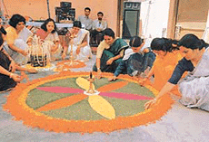 Women in traditional dresses making Pookalam to celebrate the Onam festival organised by Chandigarh Malayalee Association at Banga Bhawan Sector-35 in Chandigarh on Sunday.
