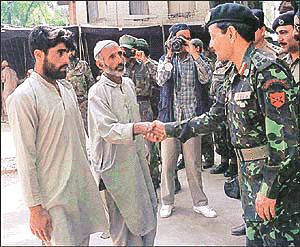 Brig A.K. Singh shakes hands with the father of a Kashmiri Muslim boy at a camp in Bandipura, 57 km north of Srinagar, on Friday. The Indian Army authorities handed over 12 Kashmiri boys to their parents who, according to them, were rescued by the security forces while being taken forcibly to Pakistan for arms training