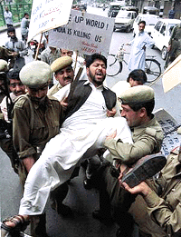 Police officers drag a pro-separatist activist during a demonstration at the occasion of the UN millenium session in the streets of Srinagar on Saturday . Shabir Ahmad Shah, a senior Kashmiri seperatist leader (not on the picture) was arrrested on the same day, along with dozens of his supporters, could finally submit a memorandum to the United Nations Military Observer Office in the evening