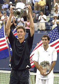 Marat Safin, left, shows off his trophy as the United States' Pete Sampras looks on after Safin's  victory in the men's singles final at the U.S. Open tennis.