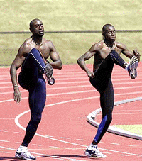 British 110 meter hurdler Tony Jarrell, left, and 4 x 100m runner Julian Golding practice on the Gold Coast, Australia, on Tuesday
