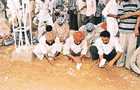Devotees dig up sand at the Gugga Marhi