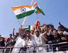 SYDNEY : Indian fans wave the national flag as they celebrate their men's hockey team's win over Argentina in preliminary competition at the Olympic Games in Sydney Sunday. India won 3-0.  AP/PTI 