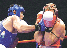 India�s Jitender Kumar (left) hits Canada�s Donald Grant Orr.