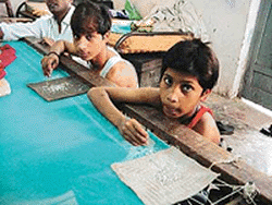 Many children like Yaseen and Raja work for about 16 hours a day for meagre wages in the suffocating environment of various embroidery units in Ludhiana. � Photo by Rajesh Bhambi