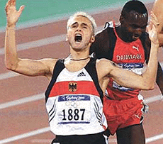 Germany's Nils Schumann raises his hands after winning the 800m final at the Sydney Olympic Games on Wednesday.