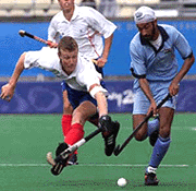 Great Britain's captain Jon Wyatt (left) tackles Baljit Singh (right) of India in classification 5-8 competition game in Sydney Olympics on Thursday. Great Britain defeated India 2-1. 