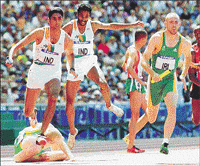 India's P. Ramachandran (left) and Paramjit Singh leap over Ireland's Robert Martin Daly at the final changeover of the heat of the men's 4x400 metre relay at the Olympic Stadium in Sydney on Friday. At right is Ireland's Paul Oppermann. 