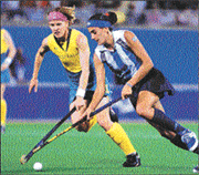 Australian Kate Starre (left) battles for the ball with Argentina's Ayelien Stepnik in the field hockey final at the Olympics on Friday. Australia won the match 3-1 and took the gold medal