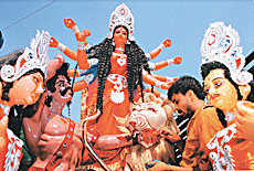 An idol of Goddess Durga gets final touches in Chandigarh's Kali Bari on Monday on the eve of the five-day Durga puja celebrations.  � Tribune photo by Karam Singh