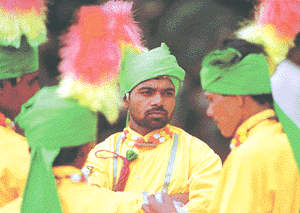 Farmers attired in traditional dresses attend a rally in Bangalore on Monday.