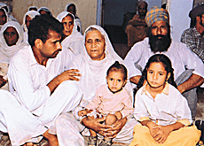 Villagers sympathise with Amar Kaur whose husband committed suicide after he was unable to sell his produce.�