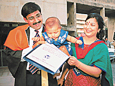 A child looks at the degree that his doctor father received at the 24th annual convocation of the PGIMER.