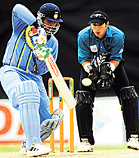 Indian captain Sourav Ganguly gets the ball away past New Zealand�s Adam Parore during their ICC Knockout Tournament final.