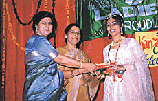 Ms Asha Miglani, President of the Geetanjali Ladies Club, gives away prize to one of the participants during the Karva Queen contest in Ludhiana on Monday. 