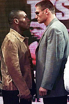 Boxers Mike Tyson (left) and Andrew Golota (right) face off during a news conference.