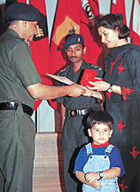 Punam Guleria receives Badge of Sacrifice from Brig Ram Partap at a function organised at Chandi Mandir on Friday.