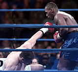 Mike Tyson, right, watches Andrew Golota, left, go down in the first round of their heavyweight fight at Auburn Hills, Mich on Friday.