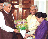Prime Minister Atal Behari Vajpayee presents a bouquet to President K. R. Narayanan on his birthday at Rashtrapati Bhavan in New Delhi on Friday.