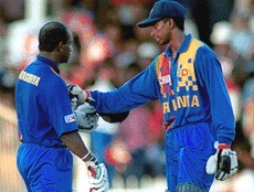 Sri Lankan batsman Russell Arnold (R) congratulates Sri Lanka�s captain Sanath Jayasuriya after he scored a century against India during the Sharjah triangular tournament final on Sunday.