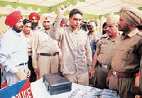 Sukhpreet Singh, alias Sukhi, leader of a dreaded gang involved in several incidents of robberies, tries to catch the attention of mediapersons by showing an audio cassette containing details about a conspiracy to eliminate him at a press conference organised by the SAS Nagar Police on Monday.