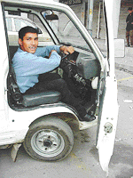 Physically handicapped Satish Chawla in his Maruti Omni 
