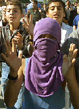 A masked youth chants slogans against Israel during a demonstration in the Gaza Strip on Friday.
