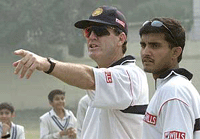 John Wright (L) discuss tactics with Saurav Ganguly, captain of Indian cricket team, during a practice session in New Delhi.
