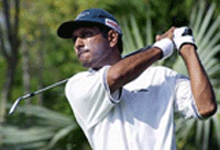 Jeev Milkha Singh of India watches the flight of his tee shot on the 16th hole during the first round of the Jonnie Walker Classic golf championship at Alpine Golf Course on the outskirts of Bangkok.