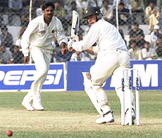 Zimbabwe�s captain Heath Streak (right) watches the ball after a shot of bowler Javagal Srinath during the first day play of first Test match in New Delhi on Saturday.
