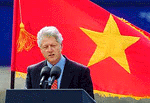 With the Vietnam flag behind him, U.S. President Bill Clinton addresses the Vietnamese business community at the International Container Terminal in Ho Chi Minh City on Sunday. 