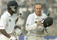 Zimbabwe's batsman Andy Flower (R) comes out of the ground after his unbeaten knock of 183 runs with teammate henry Olonga against India during the second day's play of the first Test match in New Delhi.