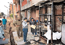 Police and CSFL officials inspect the remains of a wooden cabin after a security guard was burnt alive outside a Sector 35 hotel in Chandigarh on Wednesday.