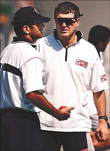 Former New Zealand cricket captain and current coach of the Indian team John Wright (R) speaks to Indian vice captain Rahul Dravid on the eve of the second Test between India and Zimbabwe in Nagpur.
